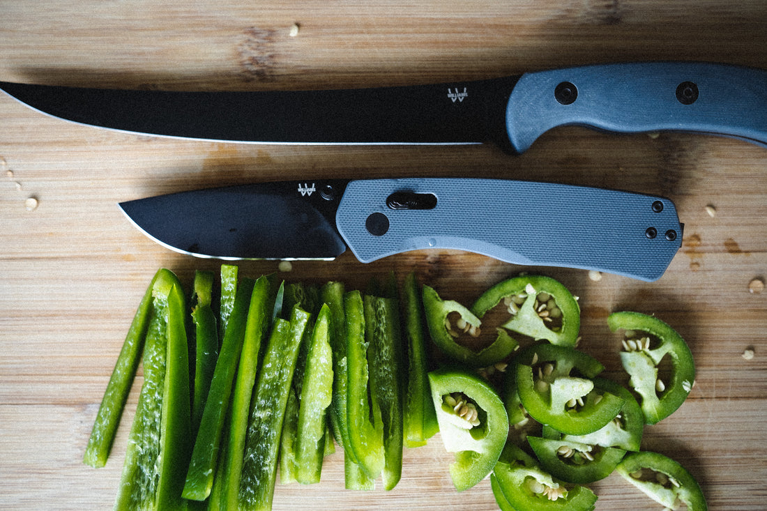 Knives beside peppers